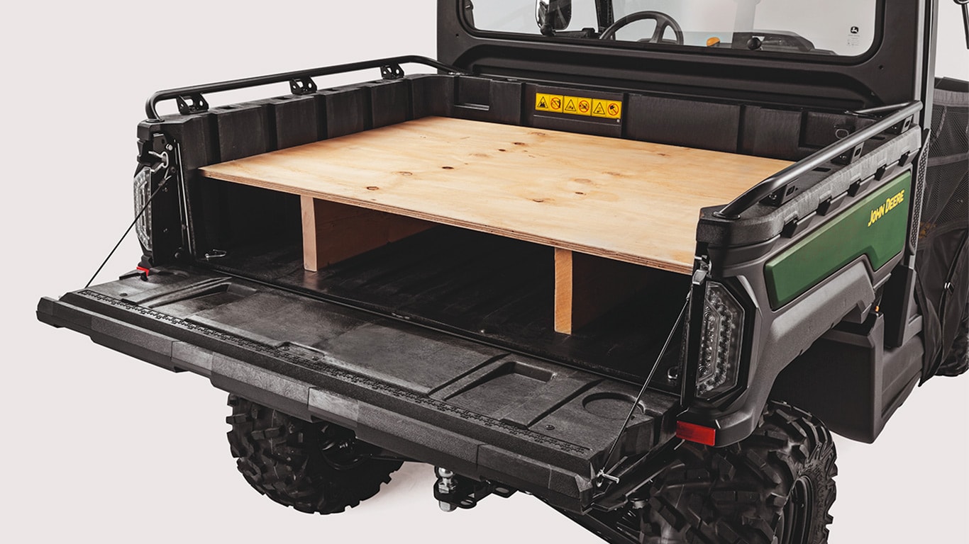 Portão traseiro de um Gator™ XUV 875M rebatido e utilizado como bancada de trabalho